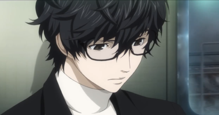 A dark haired young man with glasses leans against a wall. He is the protagonist of Persona 5.