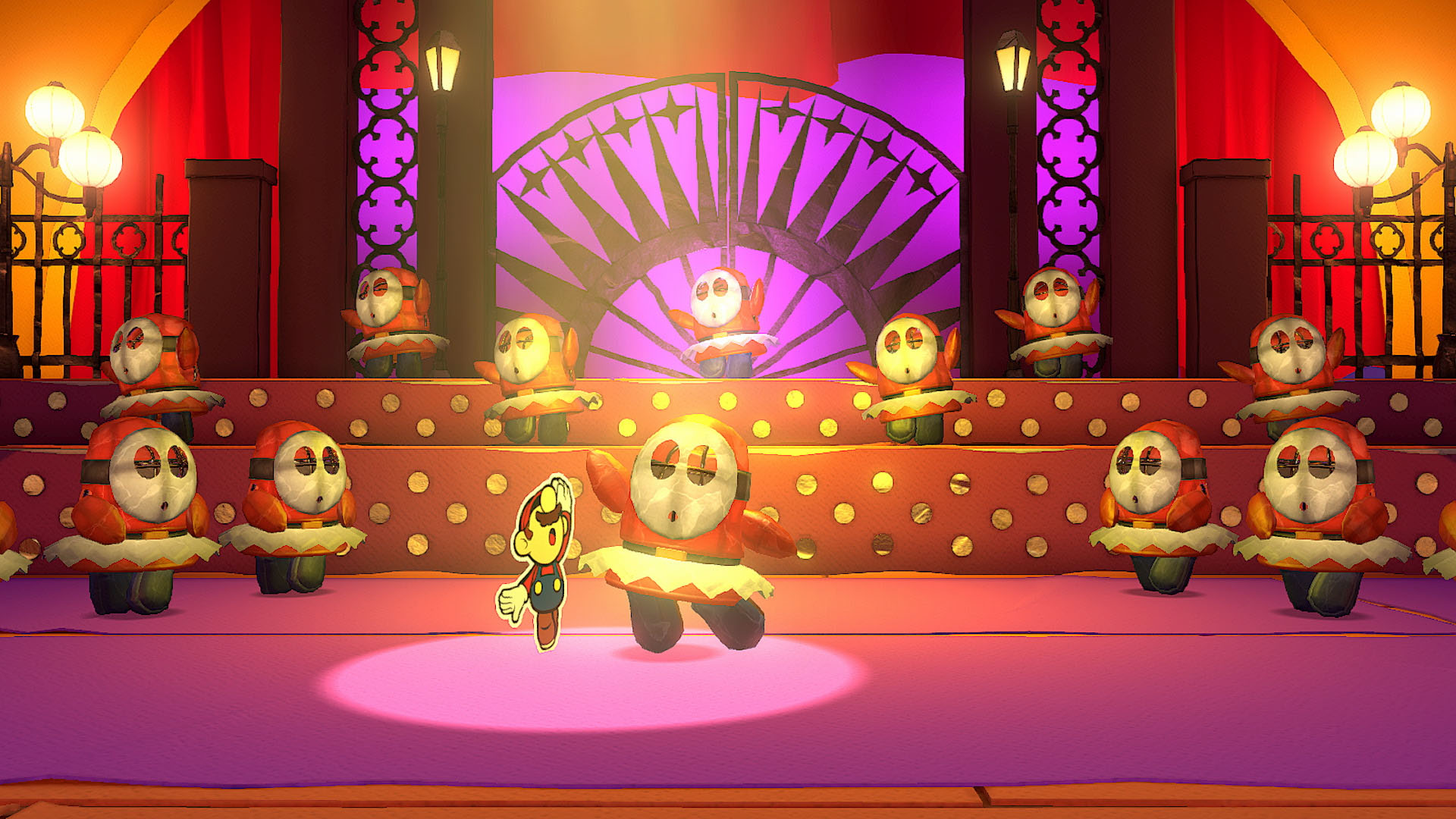 Mario dancing on stage with a bunch of mechanical Shy Guys in tutus