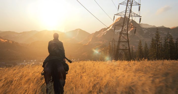 Ellie riding a horse across a golden field with a guitar on her back. She's riding towards a power line and mountains with the sun shining over them.