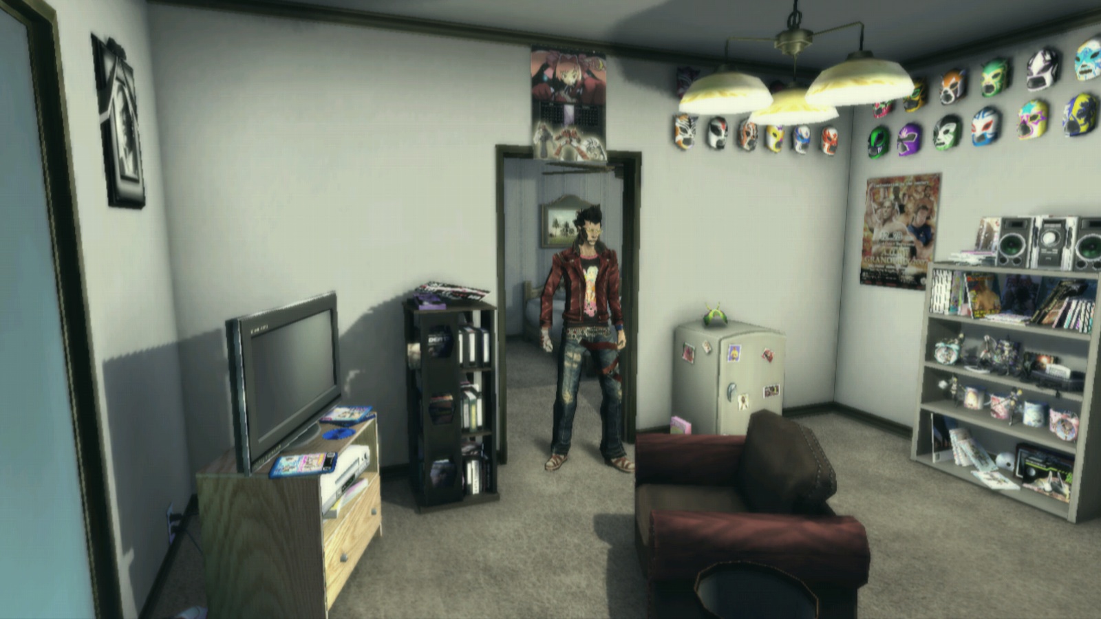 Travis standing in the doorway of what appears to be a studio apartment. There's a beat up chair, two sets of shelves, a small tv, a mini fridge covered in stickers, and luchador masks hanging on the wall.