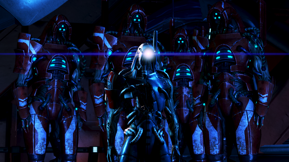 Legion standing in front of several other robots in a dark room. Legion's eye and other parts of its body are glowing in the darkness