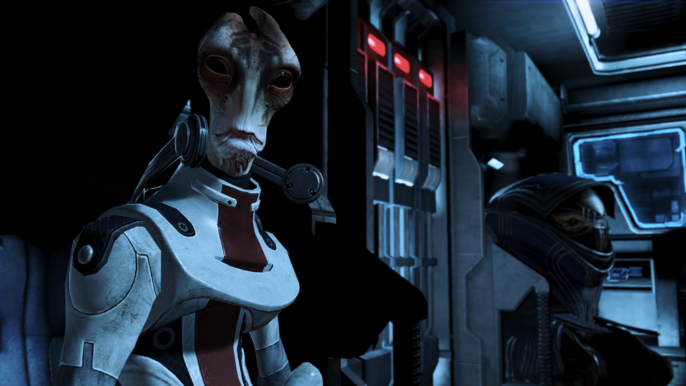 Mordin sitting on a dark shuttle on the viewer's left side. He's facing the camera and an armored krogan is sitting behind him