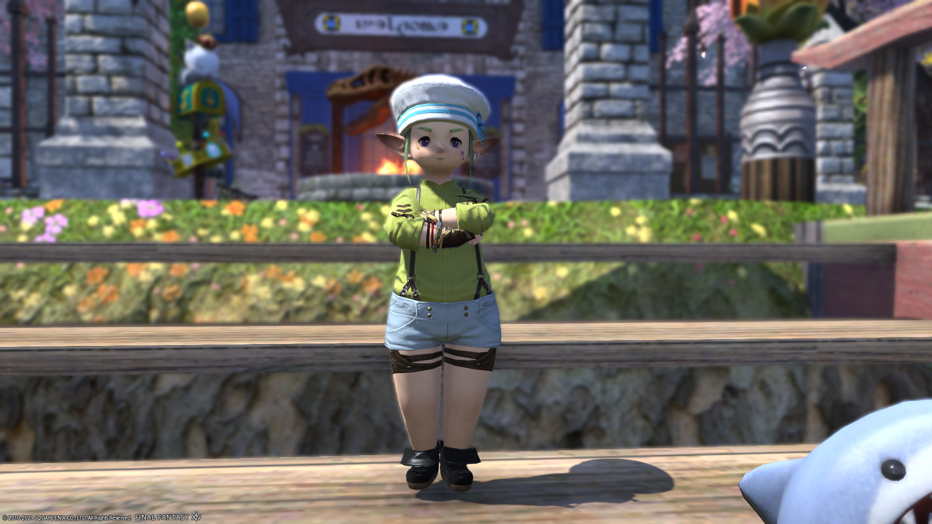 A screenshot of Boba Frog the lalafel in a green jacket, black suspenders, white shorts, and a white hat