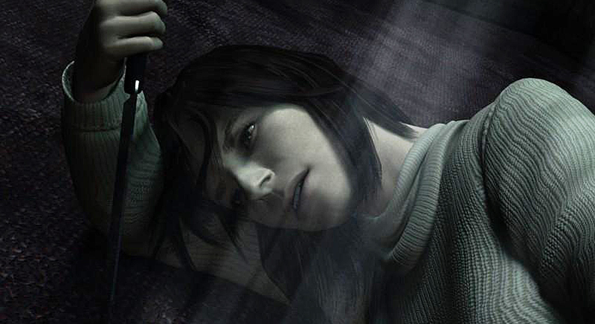 Angela lying down, holding a knife above her face