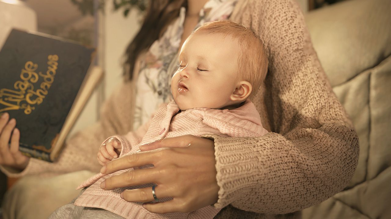 An image of Mia, Ethan's wife holding baby Rosemary