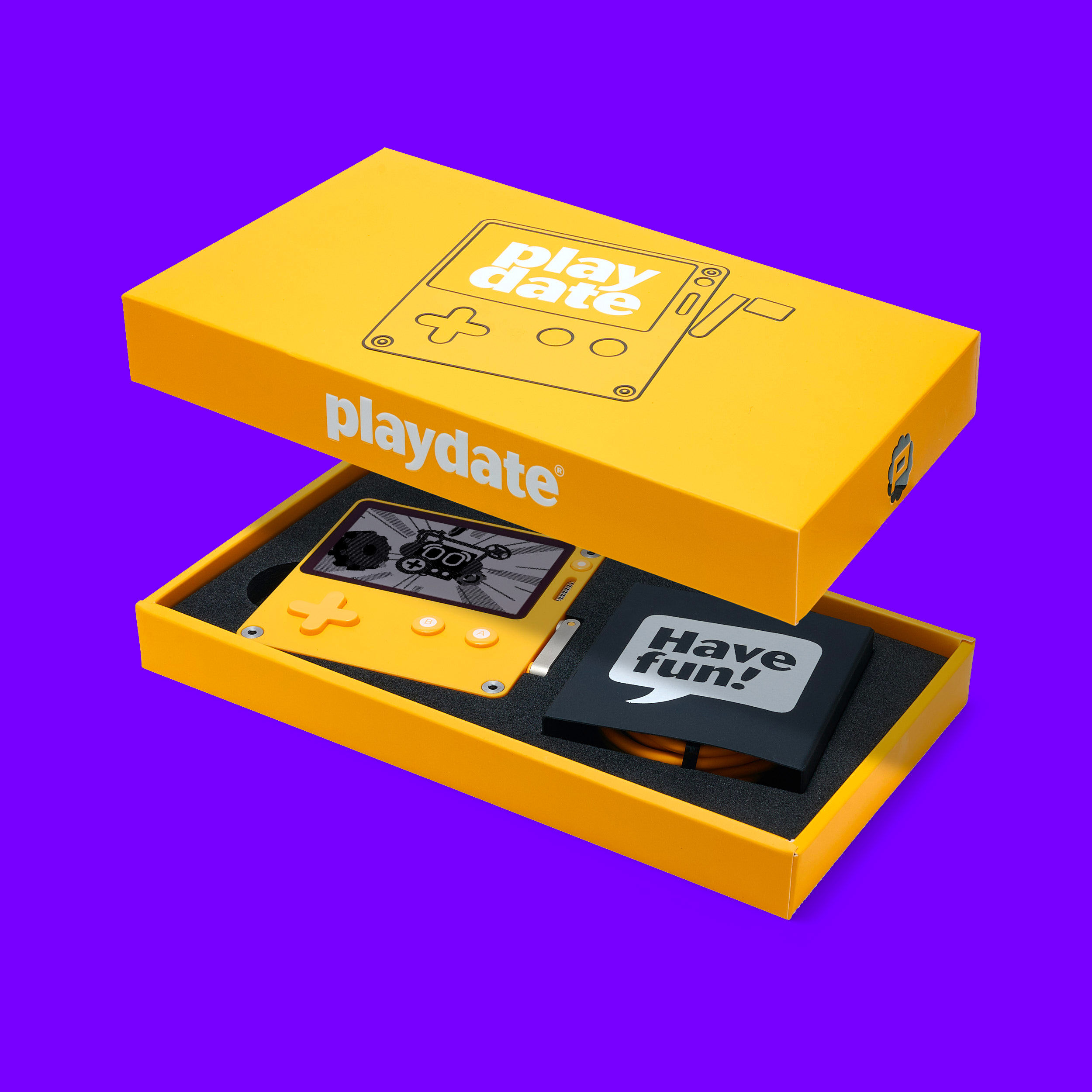 Photo of the Playdate in its yellow box with the lid floating above it