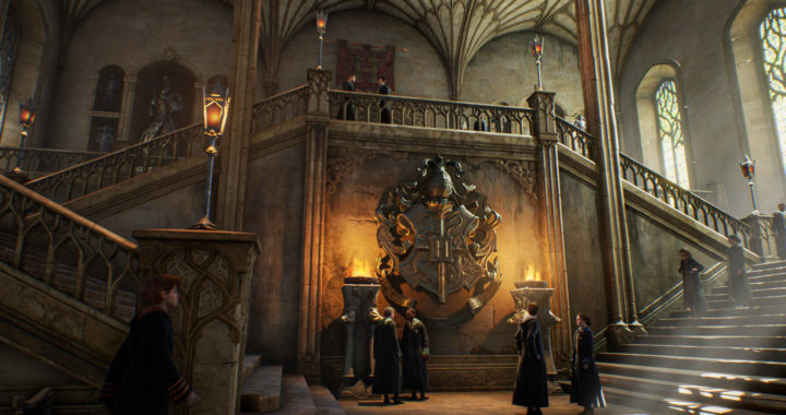 Screenshot from Hogwarts Legacy of students standing on a stairwell under the Hogwarts crest