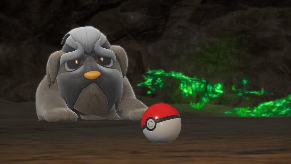 Pokémon Scarlet and Violet screenshot of Mabosstiff lying in a cave with a pokeball
